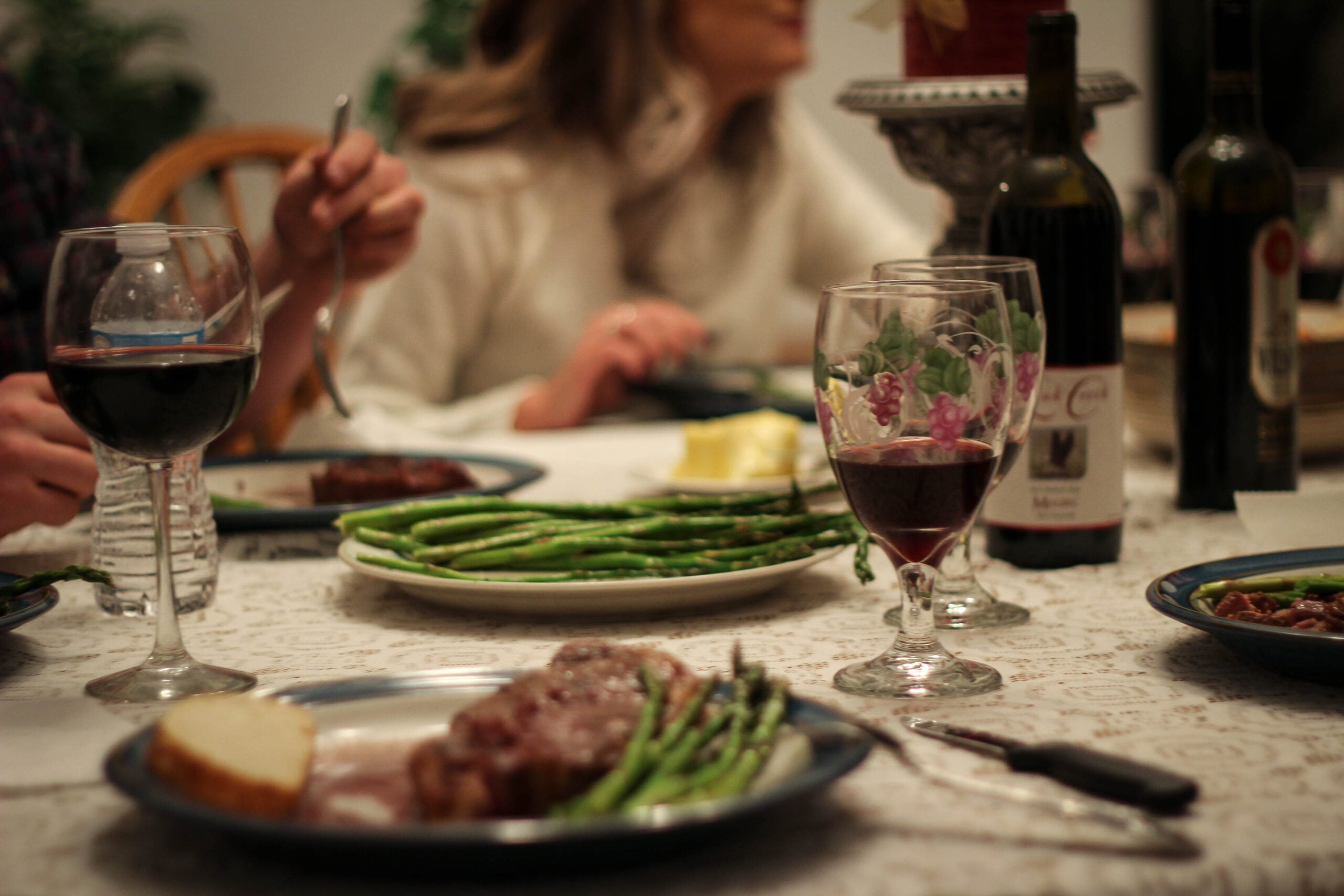 steak dinner with red wine dinner table scape with red wine and dinner